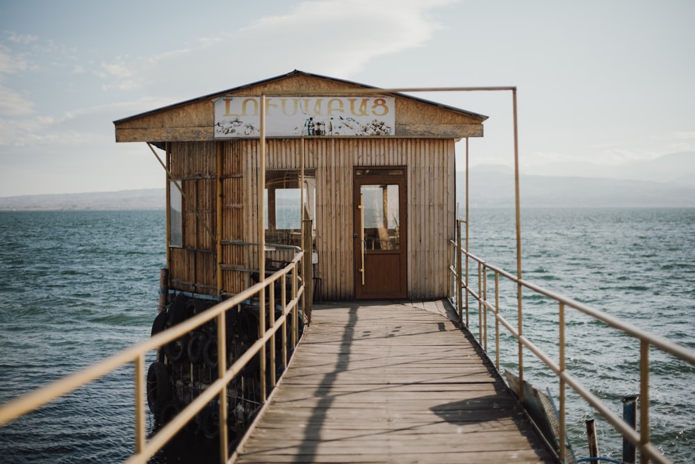 a small wooden building sitting on top of a pier