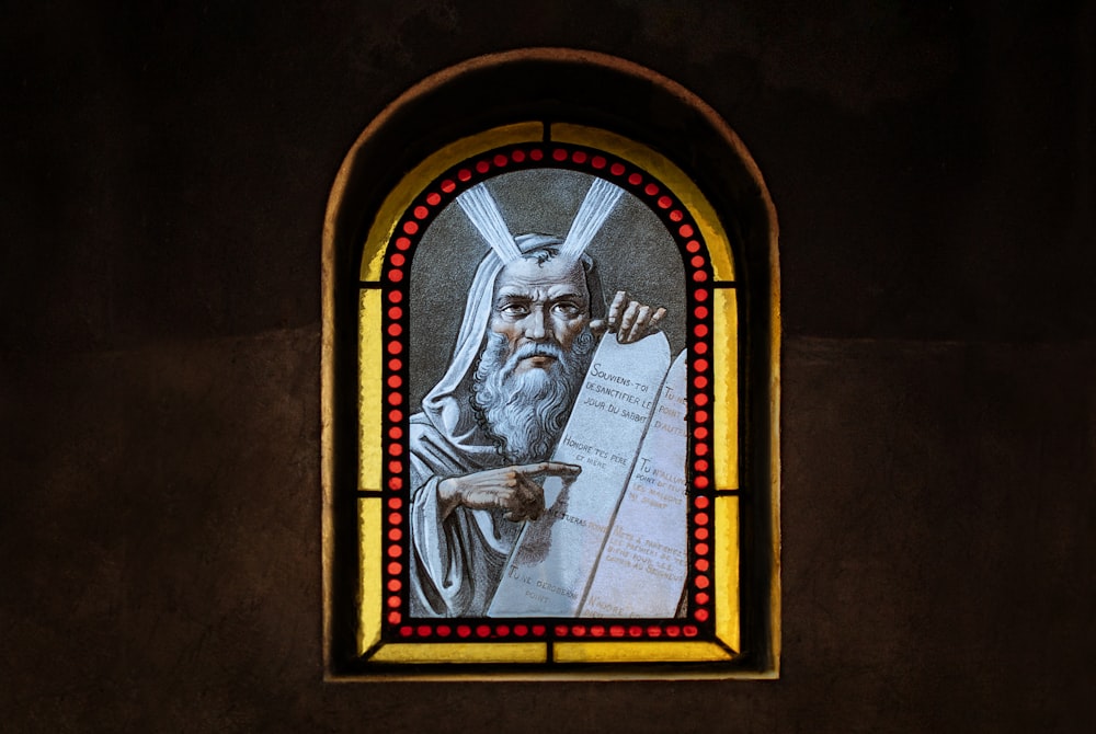 a stained glass window with a picture of jesus