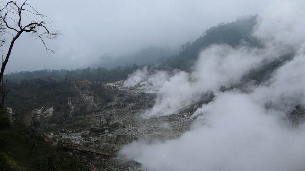 steam rises from the ground in a valley