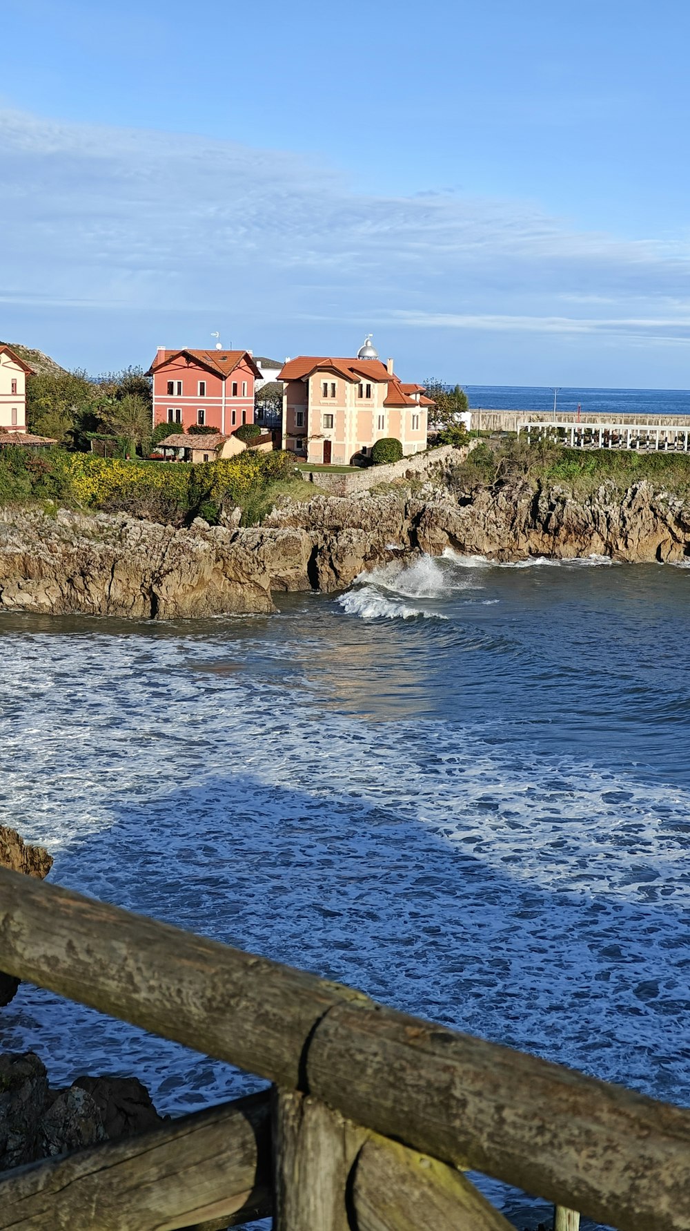 a view of a body of water with houses in the background