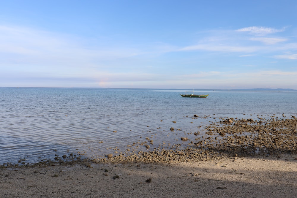 a small boat floating on top of a large body of water