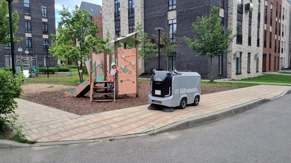 an electric vehicle parked in front of a playground