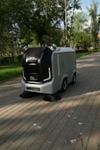 a street sweeper sitting on the side of a brick road