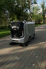 a street sweeper sitting on the side of a brick road