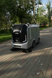 a street sweeper sitting on the side of a brick road
