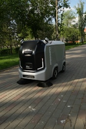 a street sweeper sitting on the side of a brick road