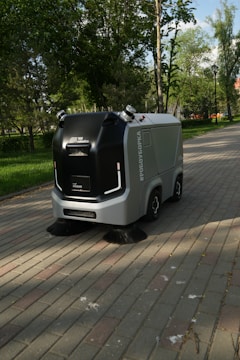 a street sweeper sitting on the side of a brick road