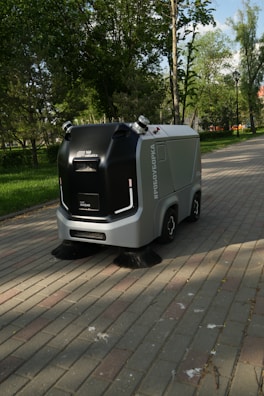 a street sweeper sitting on the side of a brick road