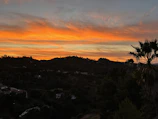 Sunset casting warm hues over the tranquil hills of Tierras Tranquilas.