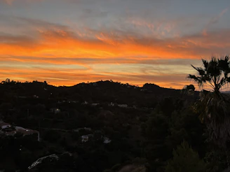 A vibrant sunset casting warm hues over rolling hills, inviting reflection and calm.