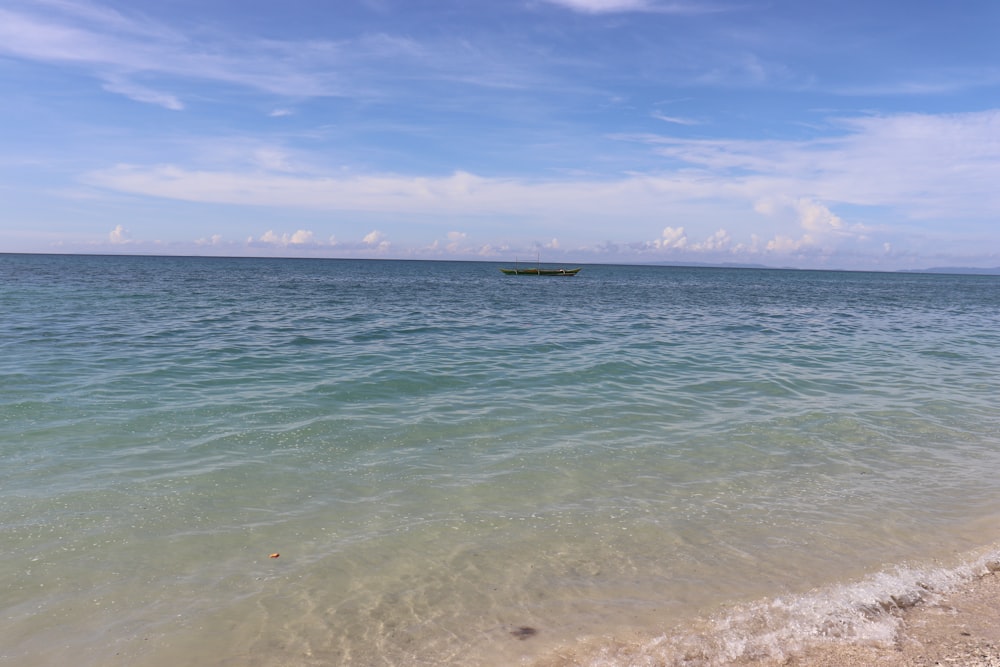 a boat floating on top of a large body of water