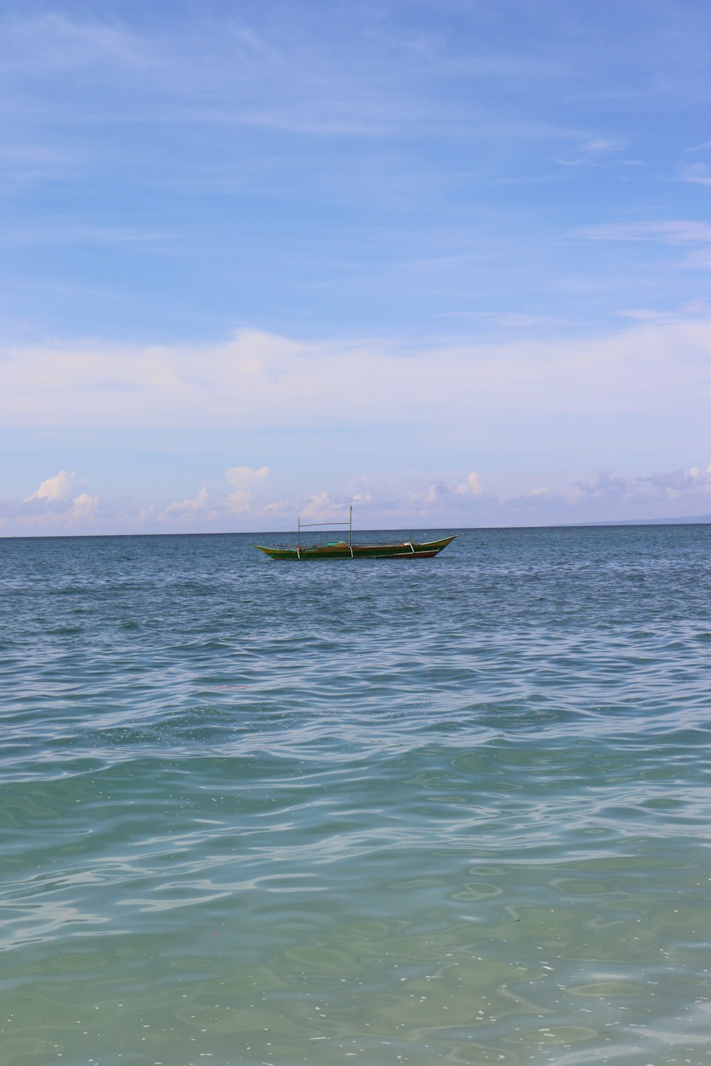 a boat floating on top of a large body of water