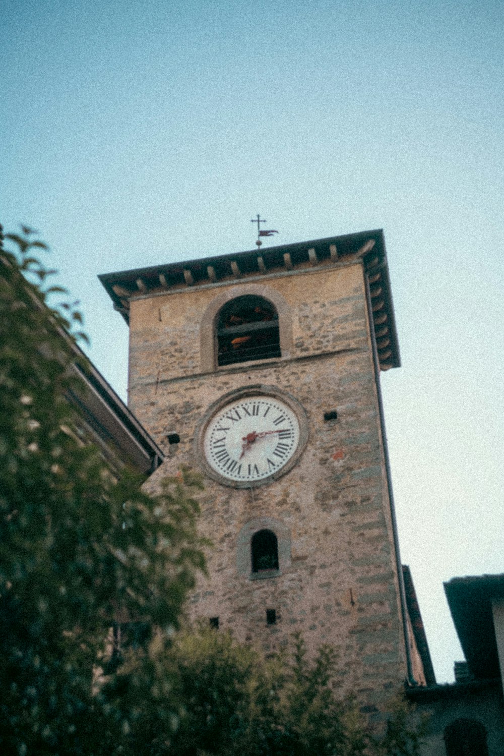 a tall clock tower with a clock on each of it's sides