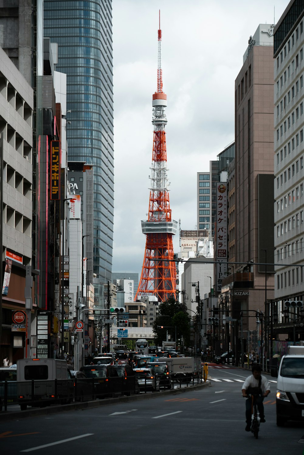 a red and white tower in the middle of a city