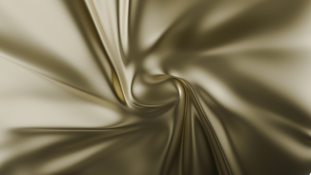 Smooth, flowing fabric with a silky texture, creating swirling patterns and subtle highlights.
