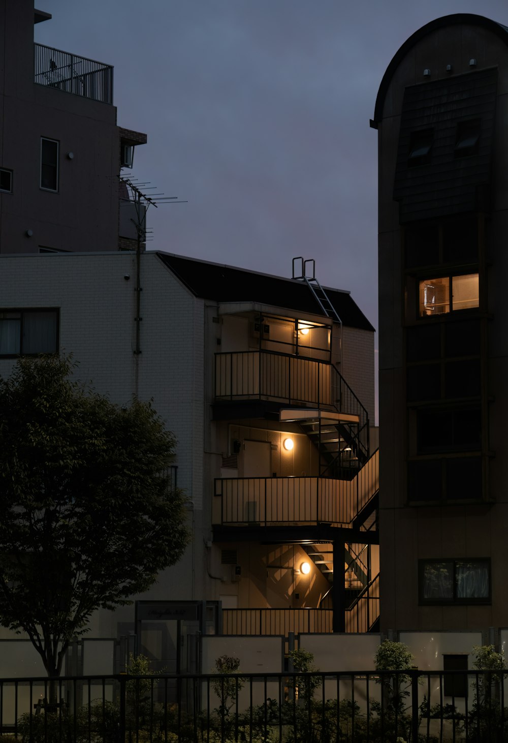 a building with a spiral staircase lit up at night