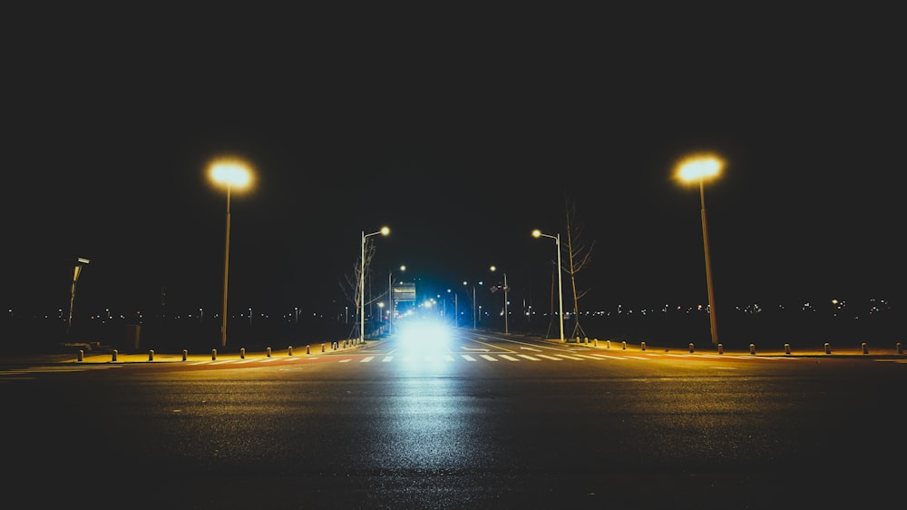 an empty street at night with street lights