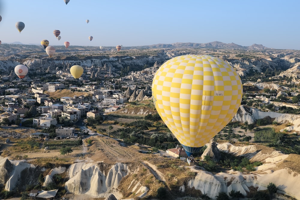 a group of hot air balloons flying over a city