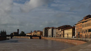 A serene riverside view with old bridges and classic architecture