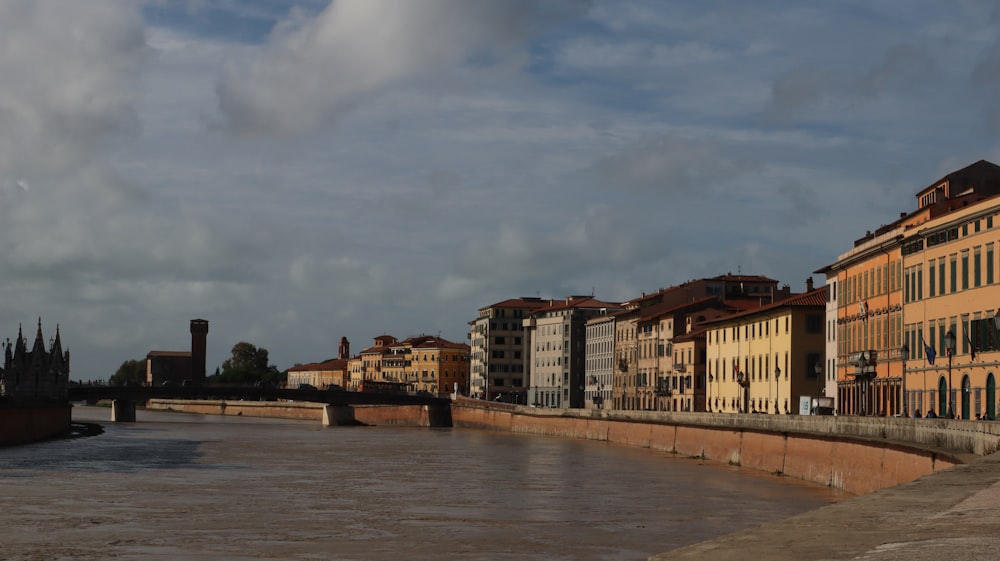 a river running through a city next to tall buildings