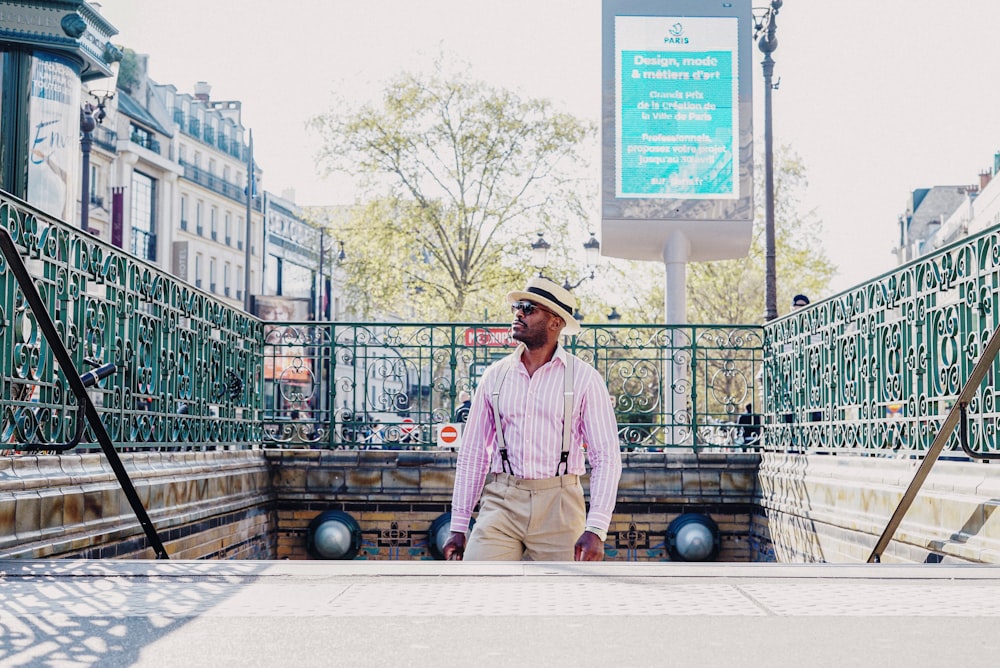 a man in a hat is standing on a platform