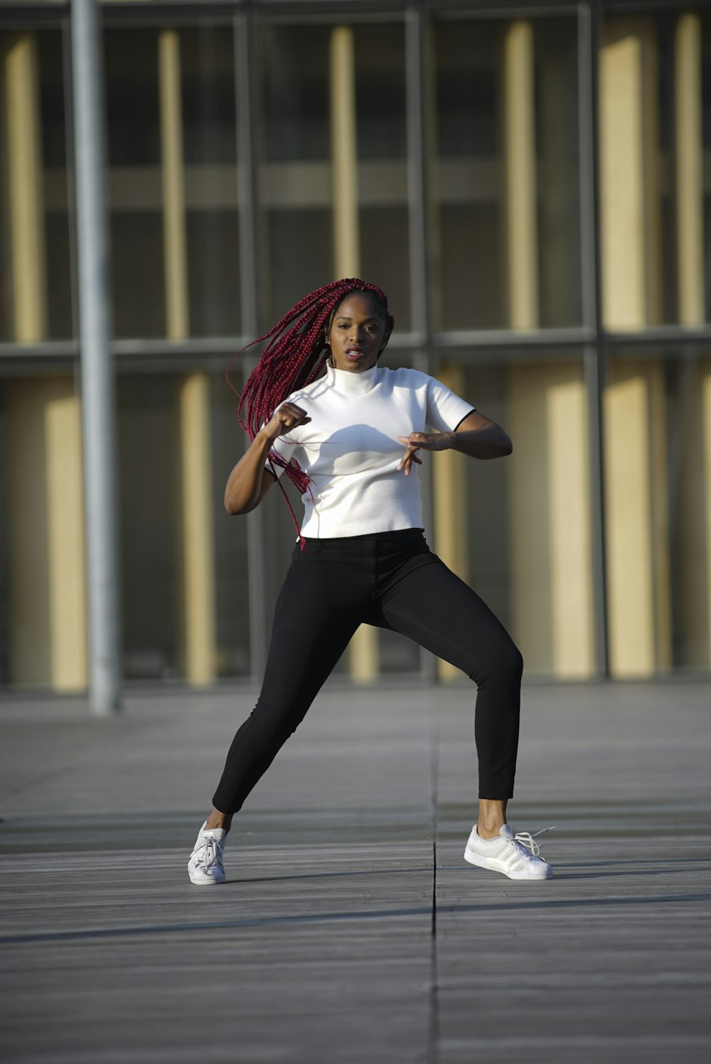 a woman in a white shirt and black pants