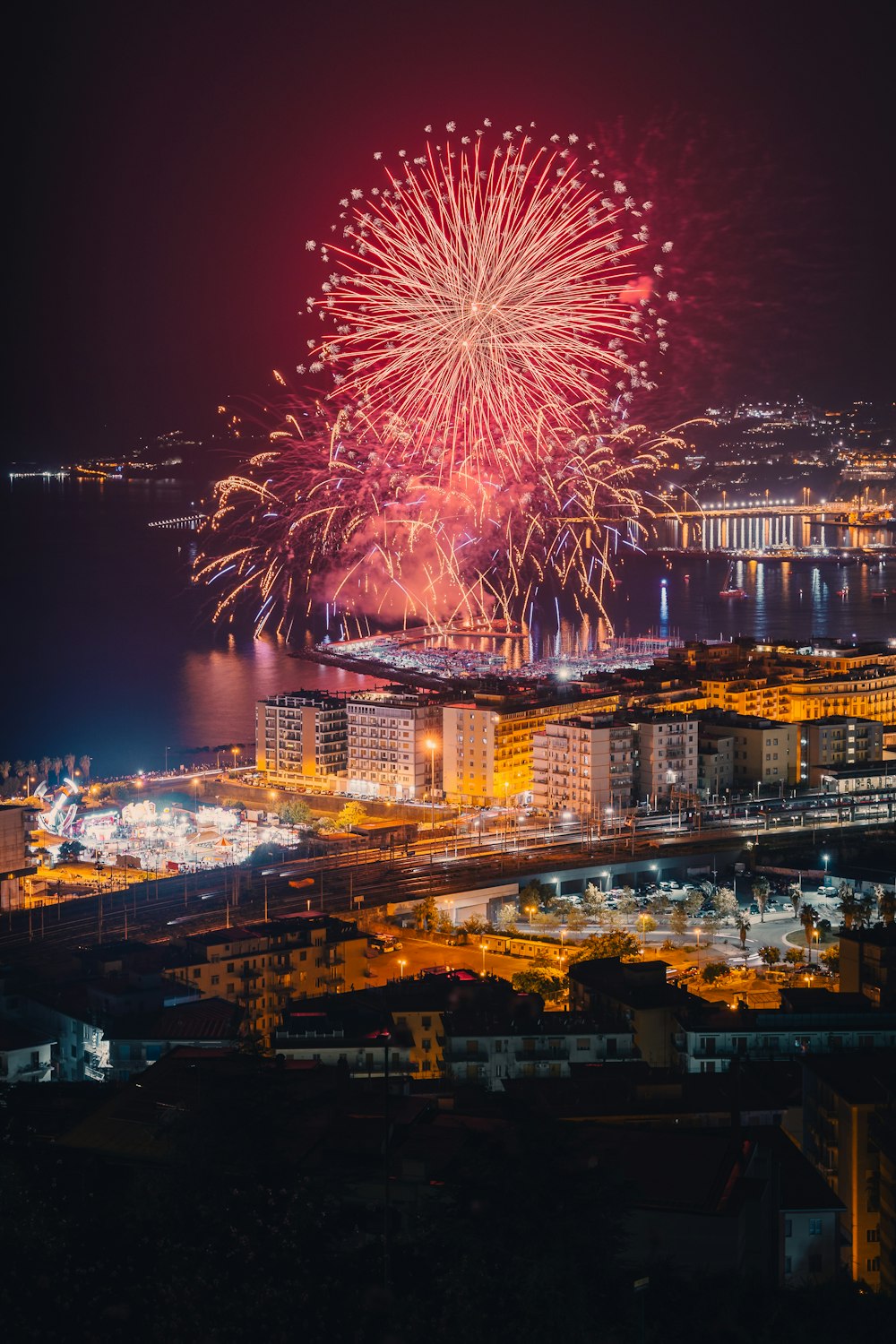 a fireworks display over a city at night