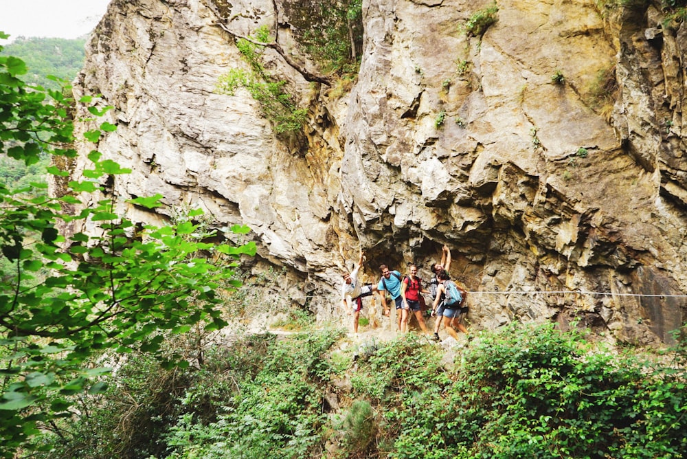 a group of people standing on a rope in front of a mountain