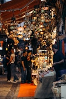 Bustling street market in Thailand filled with colorful lanterns and smiling locals.