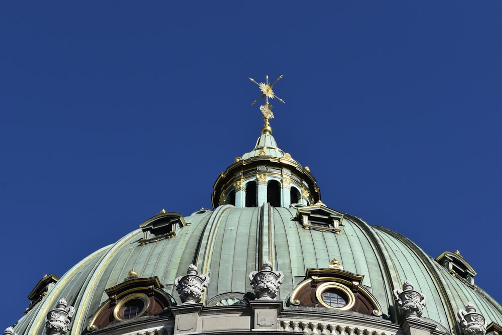 the top of a building with a cross on top