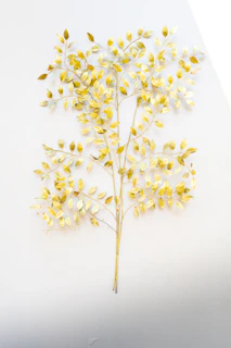 Elegant seasonal artwork featuring muted gold leaves gently falling against a warm ivory background.