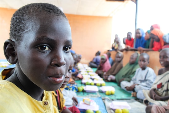 A warm photo of children sharing a meal at a community center supported by rmarma foundation.