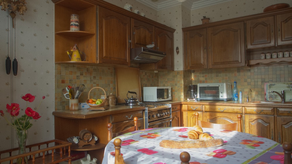 a kitchen with wooden cabinets and a table