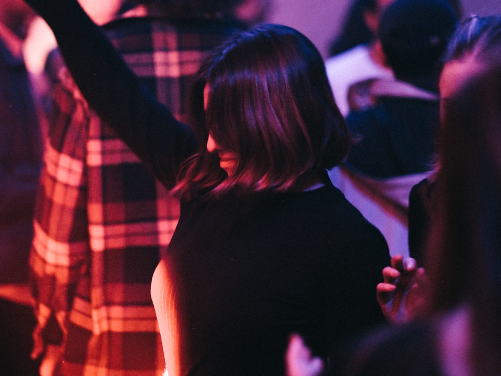 a woman standing in front of a crowd of people