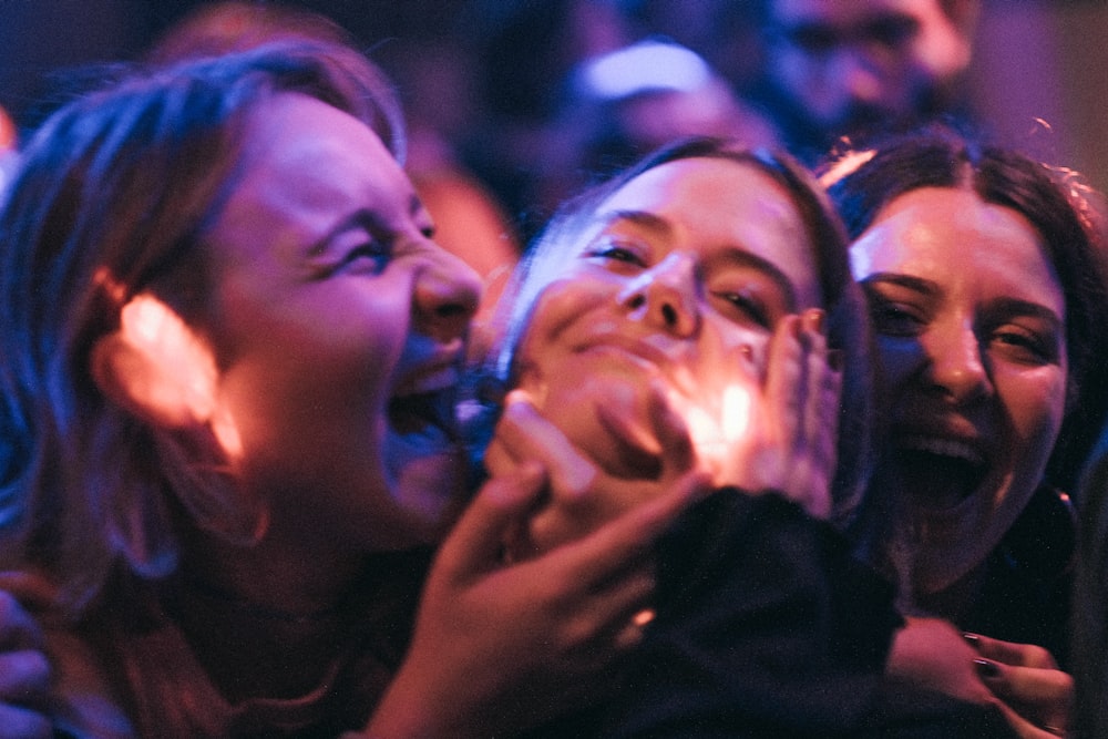 a group of women laughing and laughing together