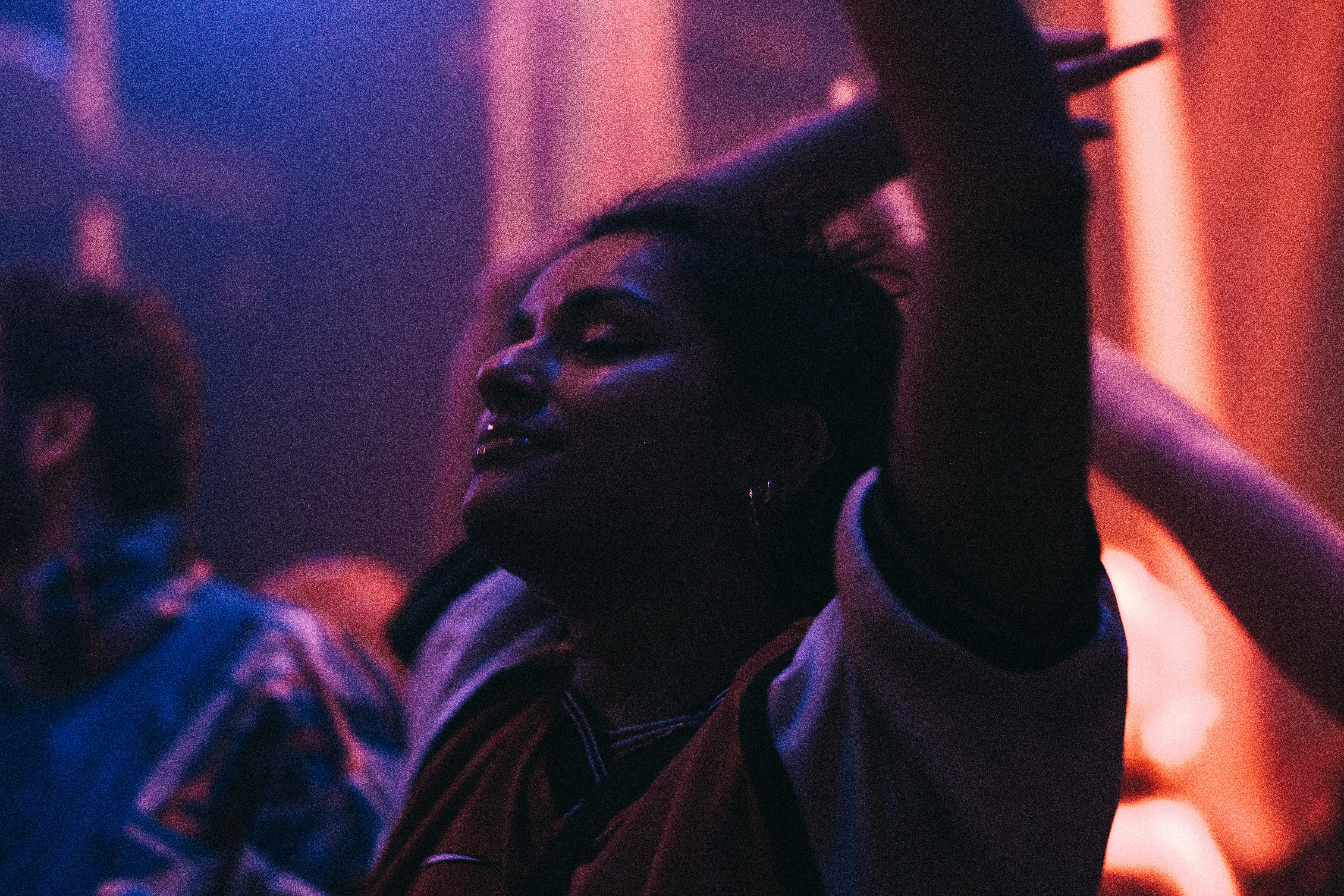 a group of people sitting in a room, people dancing in a night club