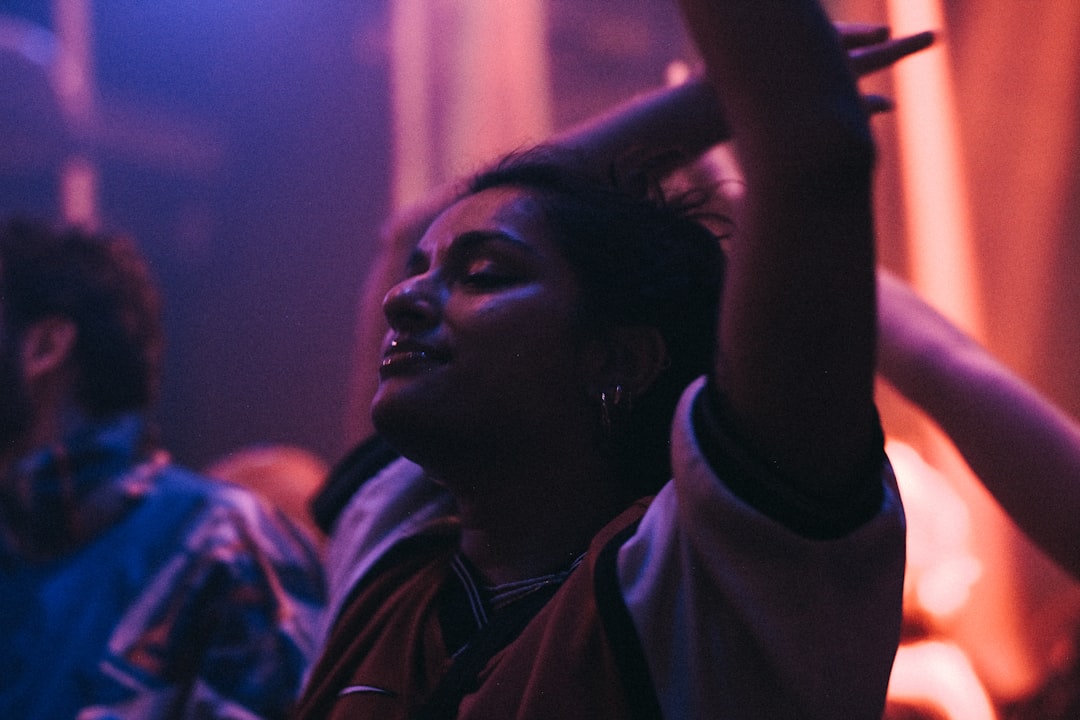 a group of people sitting in a room, people dancing in a night club