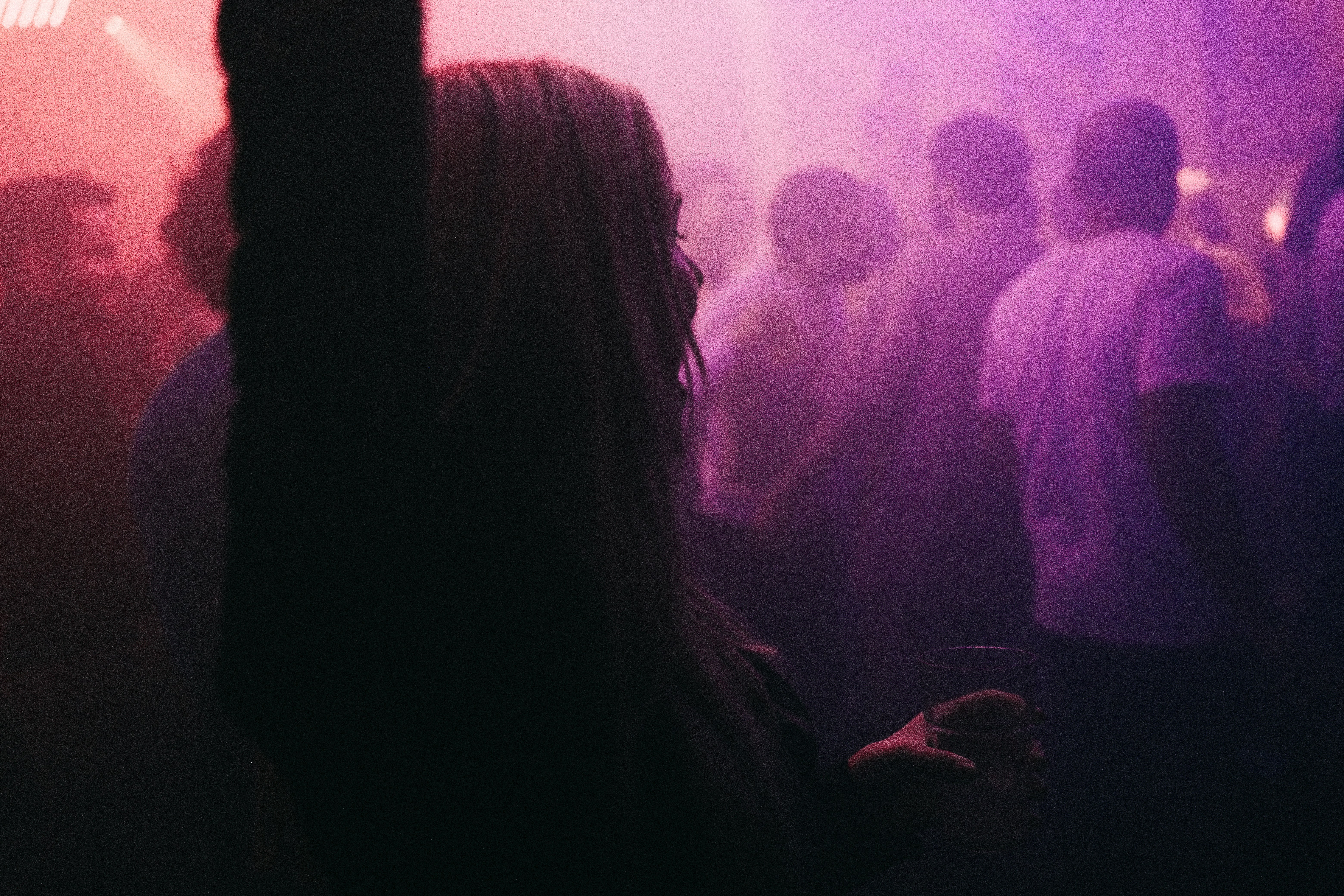 a group of people standing in a dark room