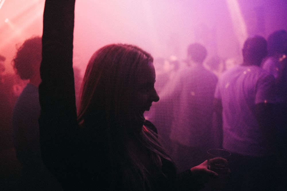 a woman standing in front of a crowd of people