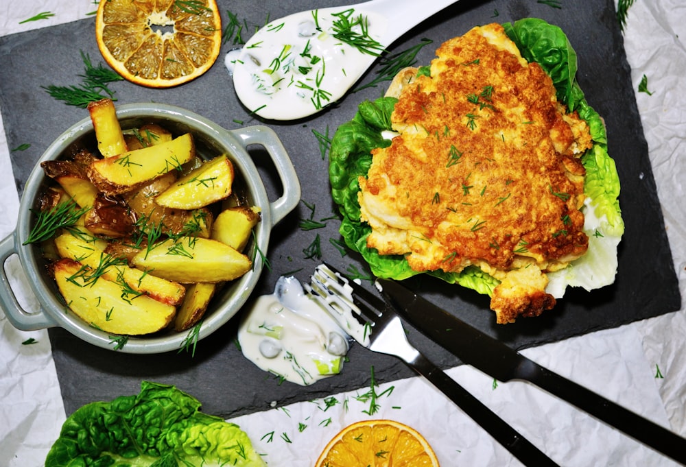 a plate of food on a table with utensils