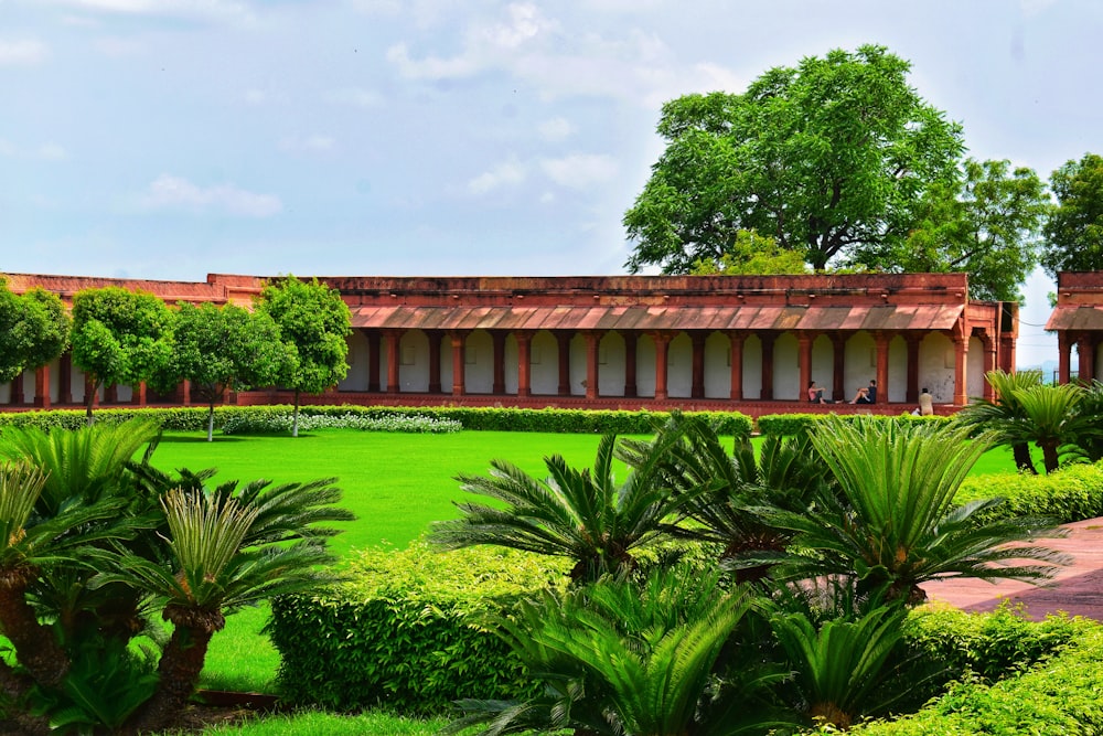 a building surrounded by lush green grass and trees
