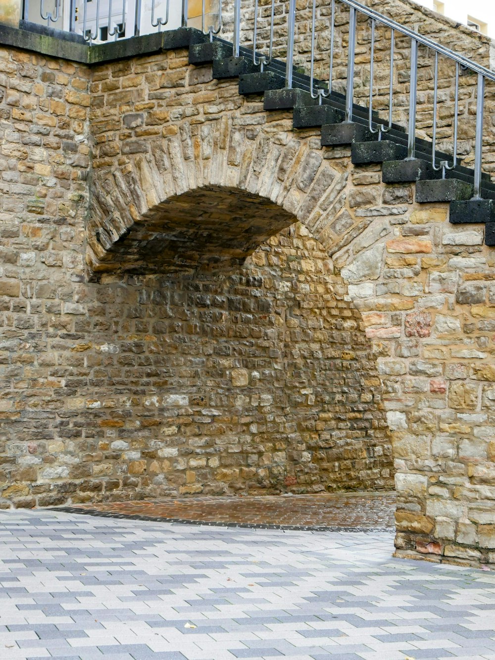 a brick wall with a staircase going up it