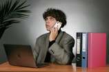 Young person reviewing personalized career report at a desk with a laptop and notes.