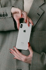a woman holding a white iphone in her hands