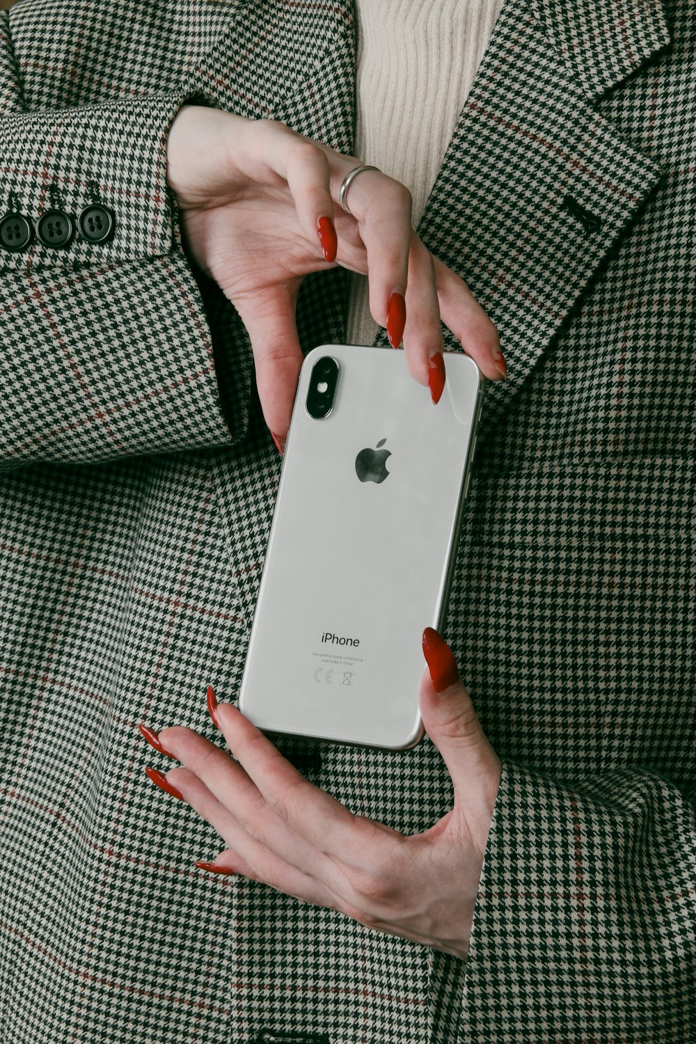 a woman holding a white iphone in her hands