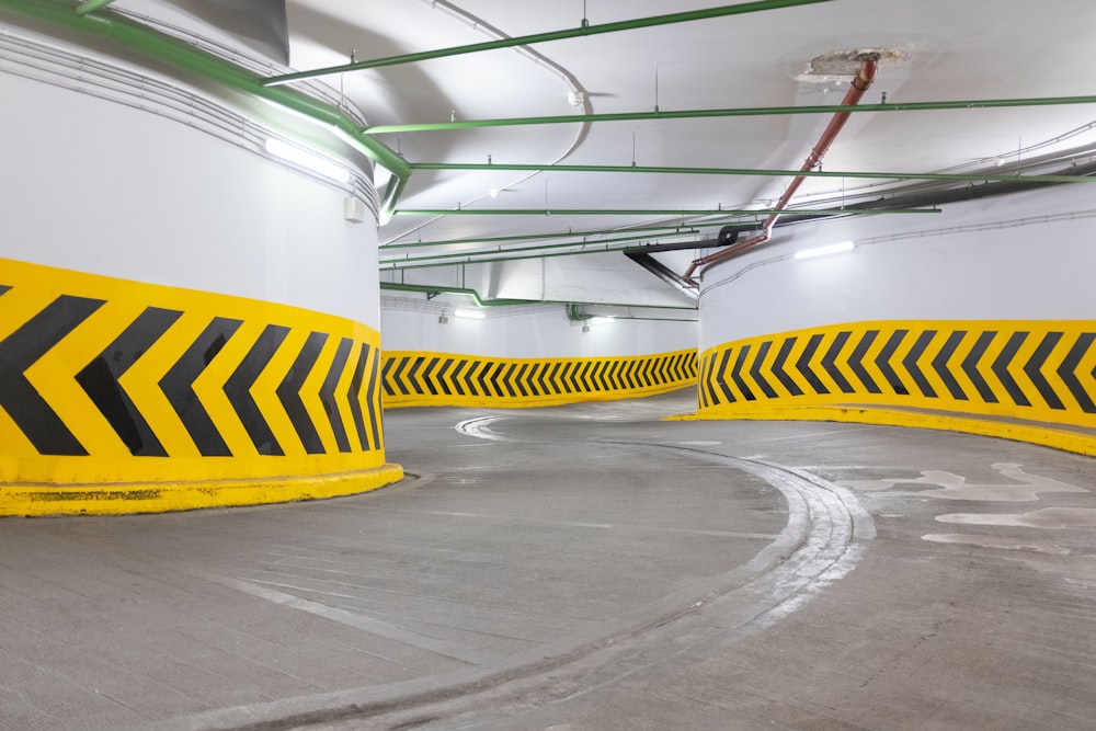 a parking garage with yellow and black striped barriers
