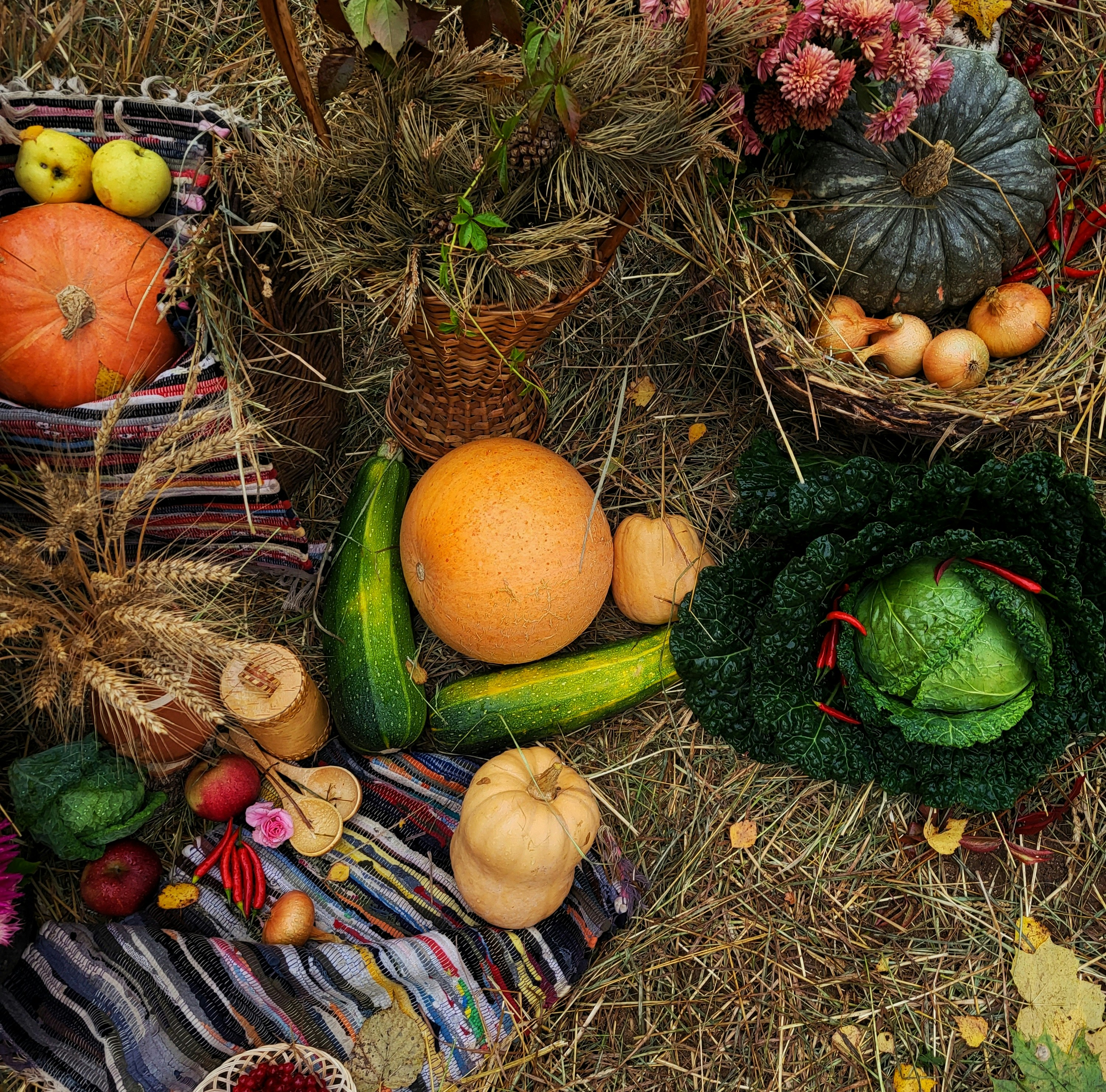 A pile of hay filled with lots of different types of fruits and