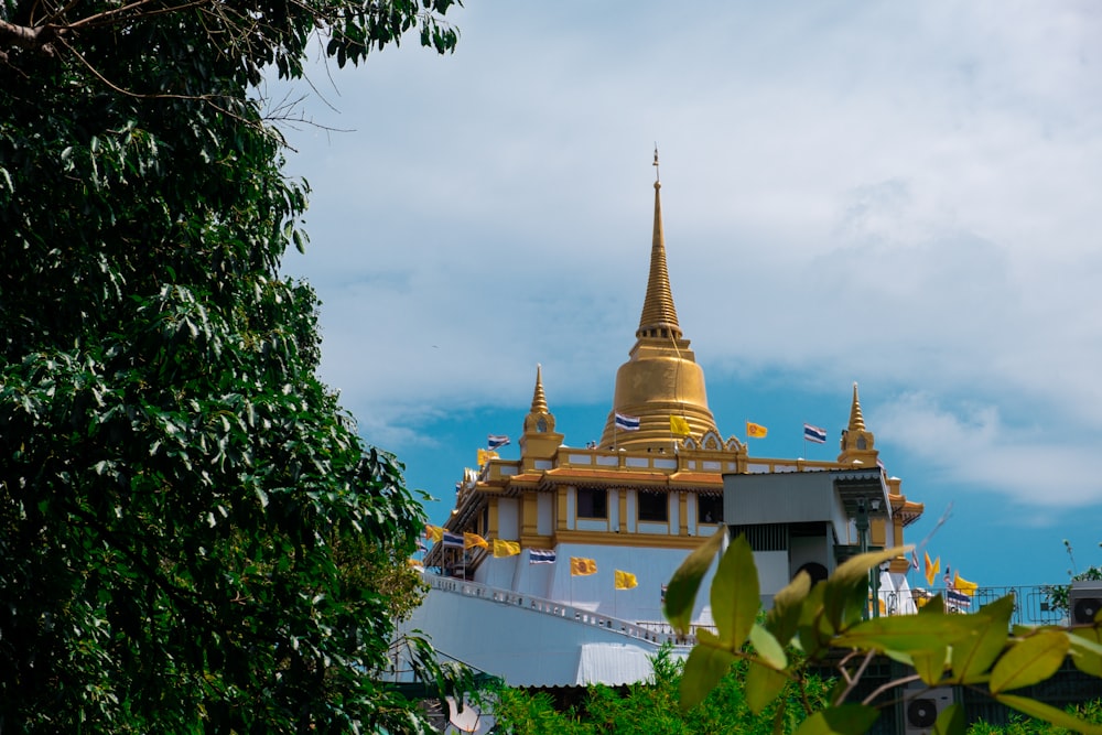 a golden and white building with a golden spire