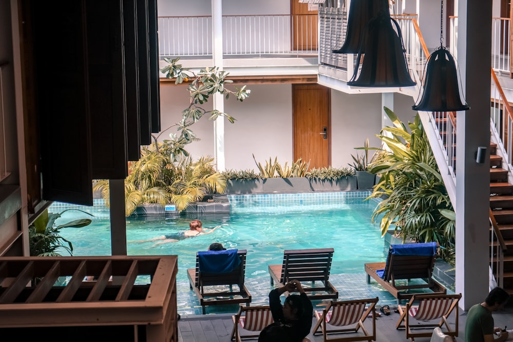 a pool in a hotel with people swimming in it