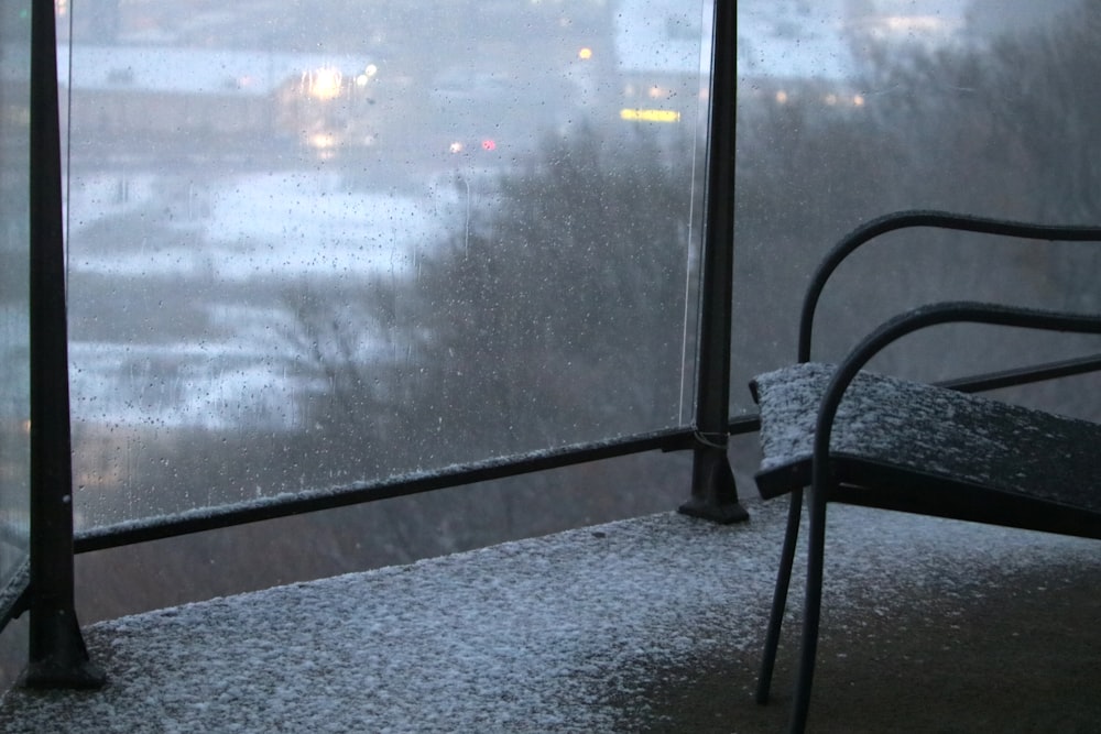 a black chair sitting on top of a window sill